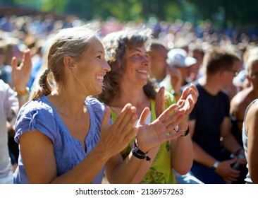 Enjoying the festival vibe. Two mature woman sitting outdoors at a music festival. - Shutterstock ID 2136957263