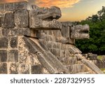 Enjoying the God Kukulkan on the platform of eagles and jaguars under a beautiful orange sunset, this is the feathered serpent of the Mayan civilization. Concept pyramid of Chichen Itza.