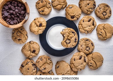 Enjoying A Group Of Chocolate Chip Cookies With Milk And A Bowel Of Chocolate Chips.  Overhead View