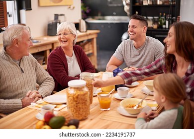 Enjoying a hearty breakfast. Shot of a happy multi-generational family having breakfast together in the kitchen. - Powered by Shutterstock