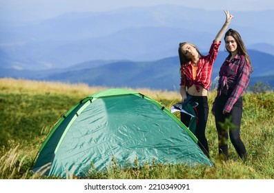 Enjoying Hot Day. Hiking Outdoor Adventure. Mountain Tourism Camp. Friends Spend Free Time Together. Family Camping. Reach Destination Place. Two Girls Pitch Tent. Wanderlust Discovery