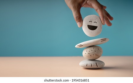 Enjoying Life Concept. Harmony and Positive Mind. Hand Setting White Natural Stone Stack to Balance. Balancing Body, Mind, Soul and Spirit. Mental Health Practice - Shutterstock ID 1954316851