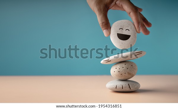 Enjoying Life Concept. Harmony and\
Positive Mind. Hand Setting White Natural Stone Stack to Balance.\
Balancing Body, Mind, Soul and Spirit. Mental Health\
Practice