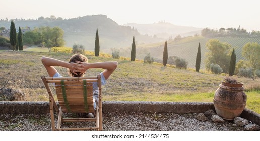 Enjoying life. Young man looking at the valley in Italy. Travel alone, active lifestyle, enjoy life, summer fun, holidays, vacations, relaxation, rest, people concept