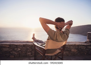 Enjoying life. Young man looking at the sea, relaxation, vacations, holidays, travel, summer fun, active lifestyle concept. - Shutterstock ID 592415045