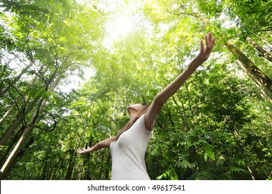 Enjoying The Nature. Young Woman Arms Raised Enjoying The Fresh Air In Green Forest.