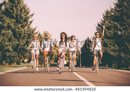 Similar – Happy young people having fun with skateboard and bicycle