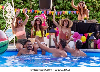 Enjoying pool party with friends. Group of friends having party by swimming pool. - Powered by Shutterstock