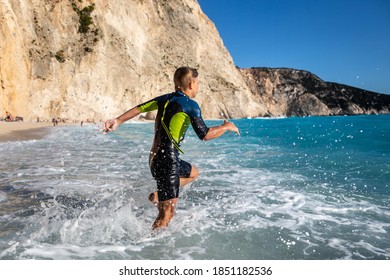 Enjoying summer and having great fun with big waves on an idyllic beach in Mediteranean