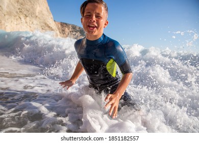 Enjoying summer and having great fun with big waves on an idyllic beach in Mediteranean