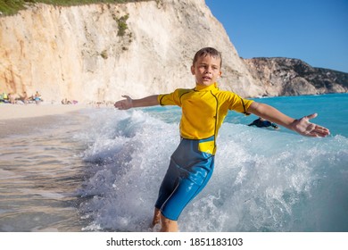 Enjoying summer and having great fun with big waves on an idyllic beach in Mediteranean