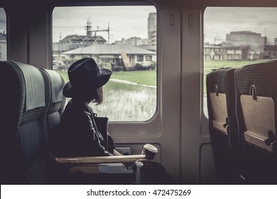 Enjoying travel. Young pretty woman traveling by the japan classic train sitting near the window. vintage filter.