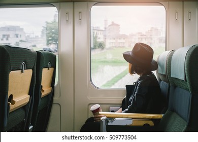 Enjoying Travel. Young Pretty Woman Traveling By The Japan Classic Train Sitting Near The Window. Vintage Filter.