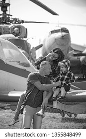 Enjoying Travelling By Air. Happy Family Vacation. Family Couple With Son On Vacation Travel. Woman And Man With Boy Child At Helicopter. Air Tour And Travel. Love Is A Family Value.