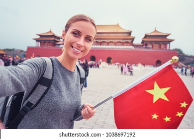 Enjoying Vacation In China. Travel And Technology. Young Woman With National Chinese Flag Taking Selfie In Forbidden City.