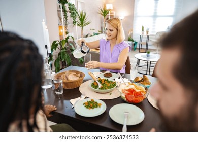 Enjoying a vibrant home-cooked meal with friends at noon - Powered by Shutterstock