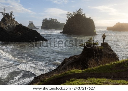 Enjoying the view of the rocky shore line and sea stacks of this stretch of coast line in southern Oregon, Secret beach around sunset.