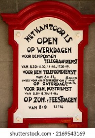 Enkhuizen, Netherlands, June 2022. Old Announcement Of The Opening Hours Of Dutch Post Office From The 1920s. High Quality Photo. Close Up. 