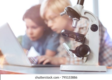 Enlarging Things. Focused Nice Intelligent Kid Using Computer For Collecting Needed Data While Working On Their Biology Project In A Lab