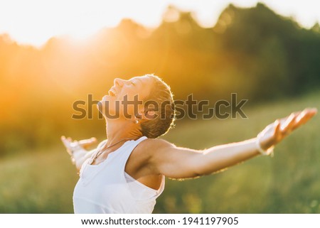 Enlightenment, a mindful woman with open arms, nurturing positive spiritual energy Foto stock © 