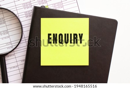 ENQUIRY text on a sticker on your desktop. Diary and magnifier. Financial concept.