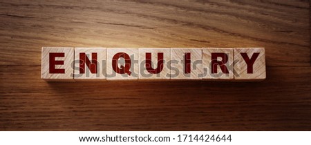 Enquiry word written on wooden blocks on wooden table.