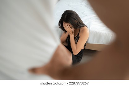 The enraged man scolding the frightened woman in the background. The concept of family and physical abuse - Shutterstock ID 2287973267