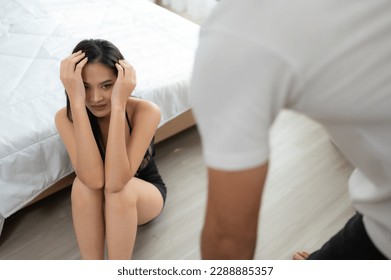 The enraged man scolding the frightened woman in the background. The concept of family and physical abuse - Shutterstock ID 2288885357