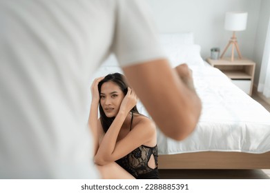 The enraged man tightened his hand to hit the frightened woman in the background. The concept of family and physical abuse - Shutterstock ID 2288885391