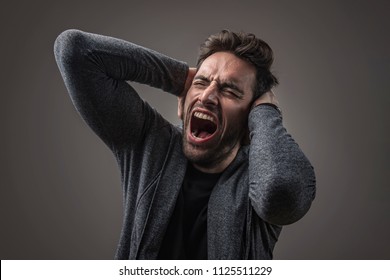 Enraged troubled man screaming in anger, crazy and mental - Shutterstock ID 1125511229