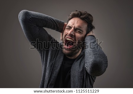 Enraged troubled man screaming in anger, crazy and mental