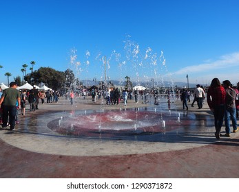 Ensenada, Mexico - November 2018: A Water Fountain Show At El Parque De La Bandera Became A Broad Walk Attracting People And Cooling Down The Sunny Day 