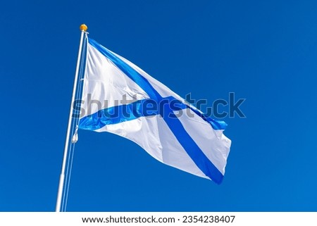 Ensign of the Russian Navy is under blue sky, also known as the St. Andrews flag. This is the stern flag of the ships of the Russian Imperial Navy and the Navy of the Russian Federation
