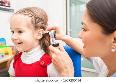 ENT Doctor Doing An Ear Exam With Otoscope To Little Girl. Hearing Clinic