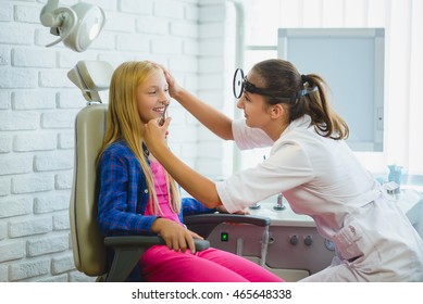 Ent Doctor Or Otolaryngologist Examining A Kid Nose