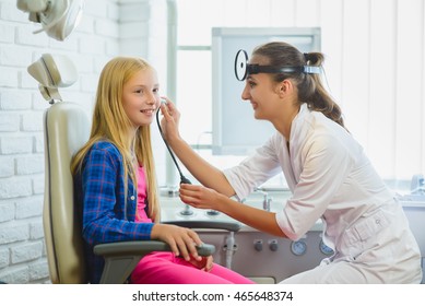 Ent Doctor Or Otolaryngologist Examining A Kid Ear