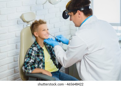 Ent Doctor Or Otolaryngologist Examining A Kid Nose