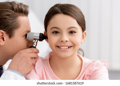 Ent Physician Examining Ear Of Cheerful Kid With Otoscope