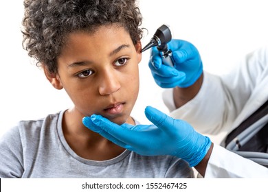 ENT physician looking into patient's ear with an instrument , Child suffereing from ear pain