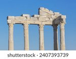 Entablature of the ruined temple of Apollo in ancient Side (Turkey) with a stone-cut relief on the frieze. Bright summer day. History, art or architecture concept