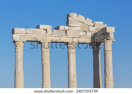 Entablature of the ruined temple of Apollo in ancient Side (Turkey) with a stone-cut relief on the frieze. Bright summer day. History, art or architecture concept