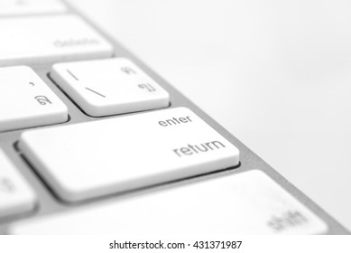 Enter button close up an soft focus keyboard computer with gray color