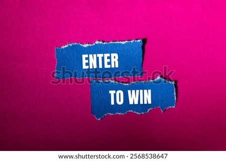 Enter to win message written on ripped torn blue paper pieces with pink background. Conceptual enter to win symbol. Copy space.