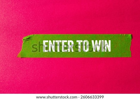 Enter to win message written on ripped torn green paper tape on pink background. Conceptual enter to win symbol. Copy space.