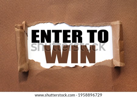 ENTER TO WIN. text inside torn brown paper. white sheet with black font.