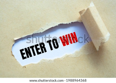 Enter to win text on paper. Word Enter to win on torn paper. Concept Image.