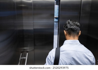 Entering elevator, businessman with shoulder bag heading to office for work, copy space. corporate, professional, commute, workwear, briefcase, transportation - Powered by Shutterstock