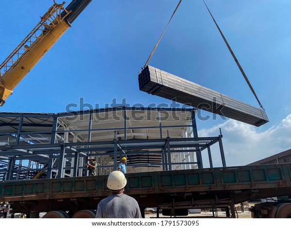 An enterprise\'s\
infrastructure construction site, under the background of blue sky,\
white clouds and sunset.