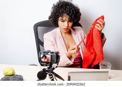 Enterprising Hispanic Millennial Woman Showing Merchandise On Live Stream With Her Clients