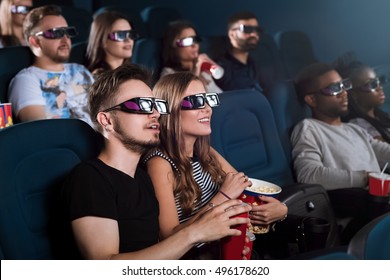 Entertained Audience. Young Couple In Love Enjoying A 3D Movie Together During Their Date At The Cinema 